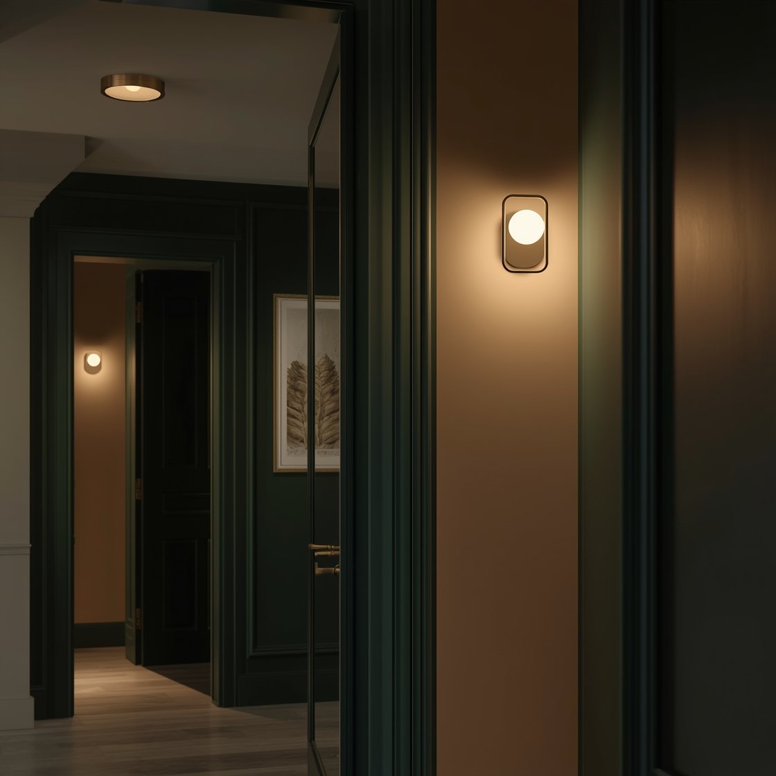 Photorealistic detail/medium shot focusing on boutique-style lighting in a garage entry: a warm LED overhead flush mount (2700–3000K) illuminating the space; a discreet motion sensor nightlight near the baseboard; and a slim brass picture light highlighting framed art above a console near the door. A full-length mirror on an adjacent wall reflects light and visually enlarges the area; optionally a slim mirrored cabinet close by for hidden essentials. The interior door is painted a high-contrast deep green, crisp and scuff-disguising. Evening scene with layered, warm lighting visible, slight angle showing the interplay of reflections and glow.