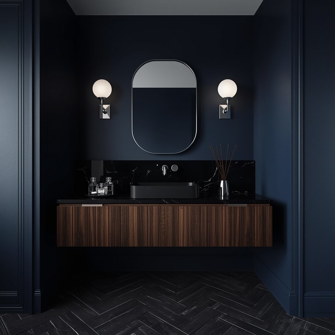 Wide, moody photorealistic shot channeling 1960s glam: deep ink blue walls with a stark white ceiling; rosewood veneer floating vanity; smoked glass backsplash panel reflecting light subtly; rectangular undermount sink with a polished nickel faucet; thin tall oval mirror in a polished nickel frame; dual opal globe bar sconce with nickel hardware; charcoal herringbone porcelain tile floor; black marble tray with perfume bottles and a minimalist incense holder. Sophisticated, low-key ambient lighting, no people.